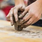 Hands molding clay