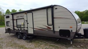 travel trailer hooked up to a vehicle