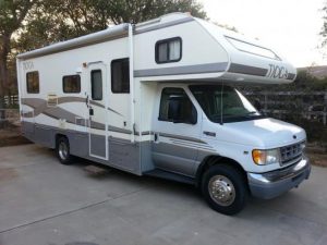 Class C motorhome parked in a driveway