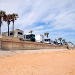 row of RVs parked at the beach