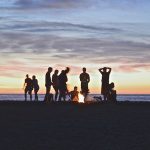 People around campfire at beach