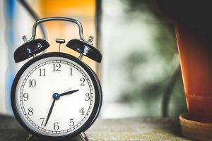 black alarm clock sitting on a table