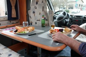 person sitting at a table and eating in an RV