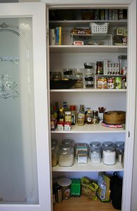 pantry filled with storage containers in an RV