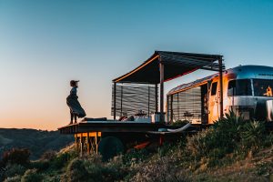 woman standing next to a parked Airstream