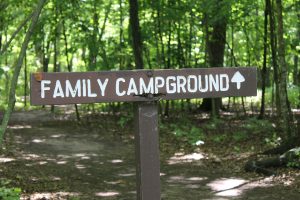 wooden family campground sign in forest