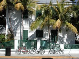 bicycles and palm trees in front of a white house in Key West, Florida