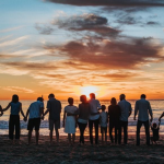 family on beach at sunset